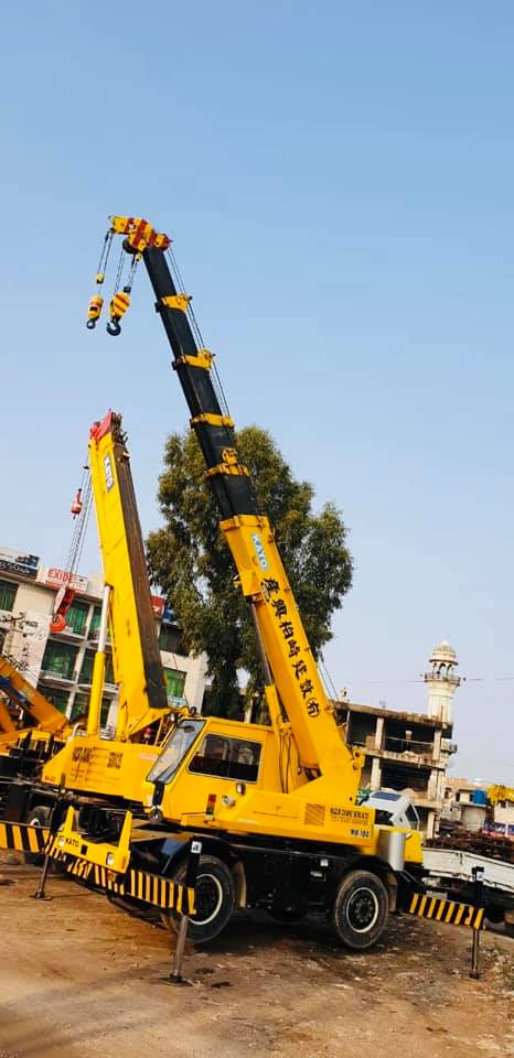 Mobile crane lifting a boom on a Wazir Crane site